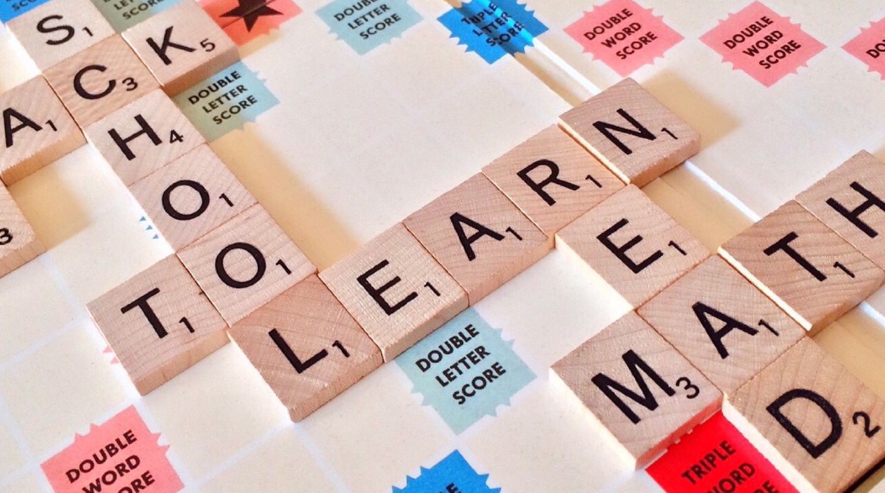 Offerings Close-up of Scrabble tiles forming words related to education and school.