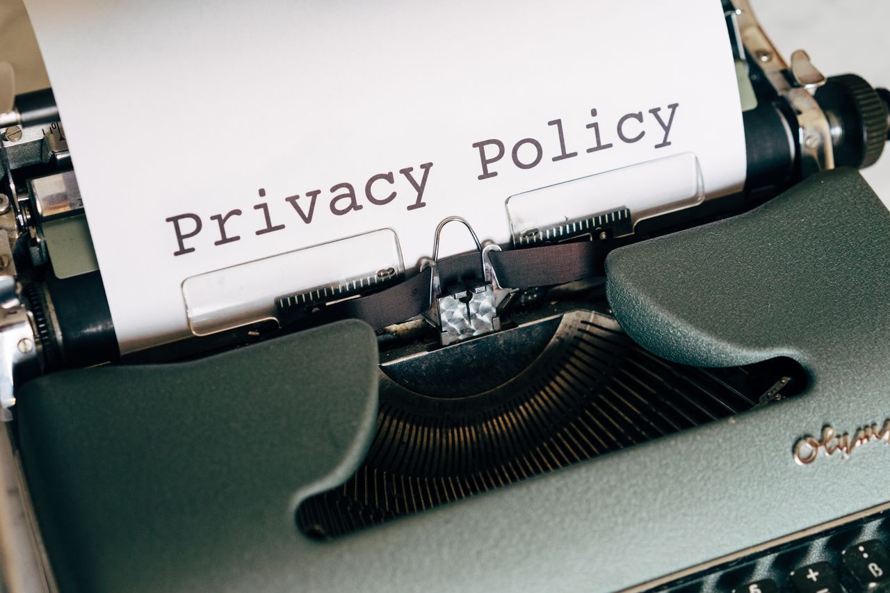 Home Close-up of a vintage typewriter featuring a privacy policy document in focus, highlighting classic technology.